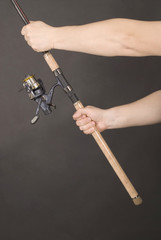 Hand holding a fishing rod