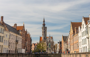 Fototapeta premium BRUGGE, Belgium - APRIL 11, 2016: Cityscape with canal Spiegelrei and Jan Van Eyck Square in the morning in Bruges, Belgium