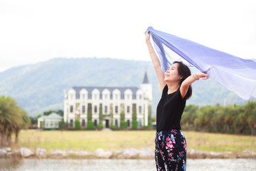 Smile asia women relax near castle and lagoon.
