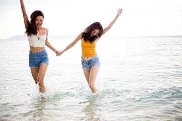 Two friend are having fun on the beach