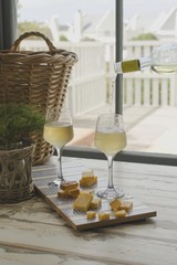 Two glasses of white wine with cheese, rustic, selective focus