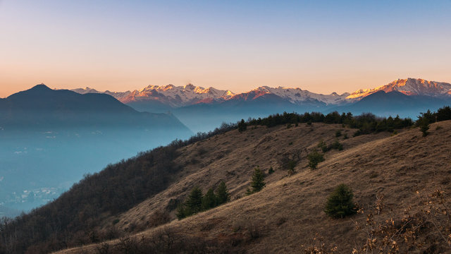 Mountain silhouette and stunning sunlight at dusk, italian Alps