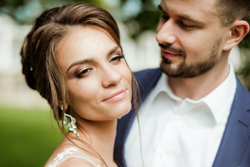 Young wedding couple enjoying romantic moments outside on a summer meadow