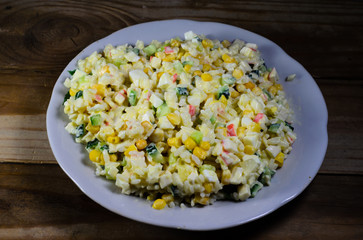 Salad with crab sticks, corn, cucumber, and eggs