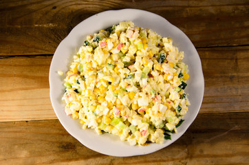 Salad with crab sticks, corn, cucumber, and eggs