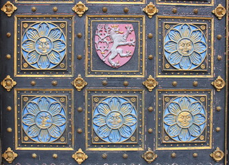 Wooden door with emblems in Prague, Czech Republic