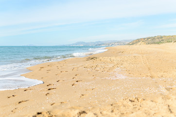 Seascape and footprints on the beach