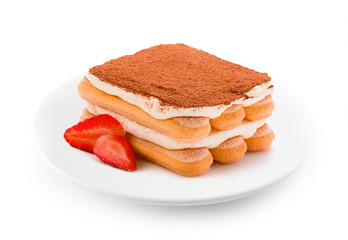 Tiramisu with strawberry on plate isolated. Clipping path