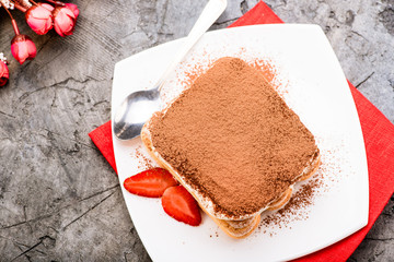 Tiramisu with strawberry on the table. Top view.