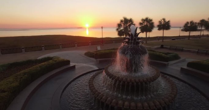 Rotating aerial perspective of the Pineapple Fountain at sunrise in Charleston, SC