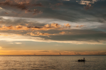Fishermen at dusk  in Bunaken National Marine Park, North Sulawesi, Indonesia