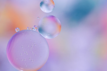 colored oil droplets on the water surface