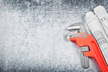 Pipe wrench blueprints on metallic background copy space constru