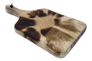 Well used wooden kitchen cutting board with burned and charred marking.