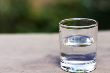 Drink a glass of water on a wooden floor.
