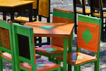 colurful painted cow hide chairs in the center of El Jardin Colombia of the local coffee shops