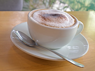 Hot coffee cappuccino white cup with silver spoon 