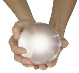 What does the future hold - female fortune teller with large crystal ball held in cupped hands with a soft white center isolated on a white background