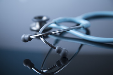 Mint Stethoscope close up view. Blue color Stethoscope with reflection. Stethoscope background. Stethoscope with reflection on glossy black background. - 132059742