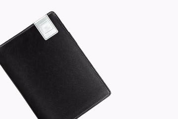 Black leather book on white backround.
