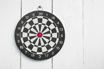 Dartboard hang on painted white color wood wall