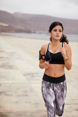 Young brunette jogging on the beach