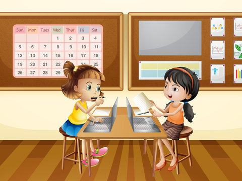 Two girls working on computer in classroom