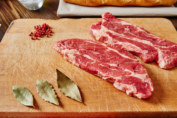 Raw meat on wooden cutting board