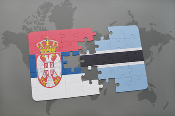 Obraz premium puzzle with the national flag of serbia and botswana on a world map