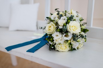 A wedding bouquet lying on the bench