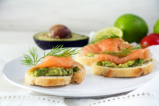 Baguette sandwiches with smoked salmon and avocado cream or guacamole