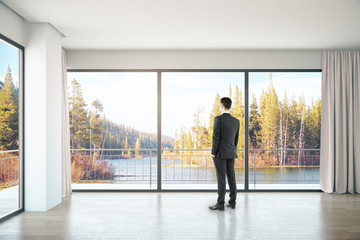 Man in room with landscape view