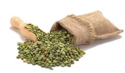 Green peas in a burlap with a shovel