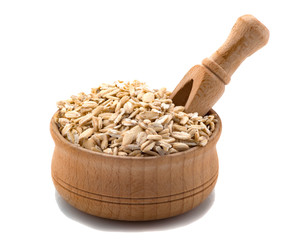 Raw Oatmeal in a wooden bowl with a spatula