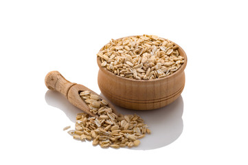 Raw Oatmeal in a wooden bowl with a spatula