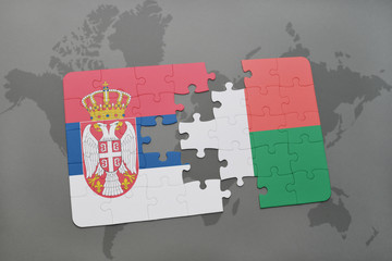 puzzle with the national flag of serbia and madagascar on a world map