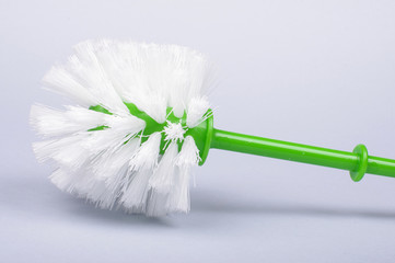 Toilet brush with green handle isolated