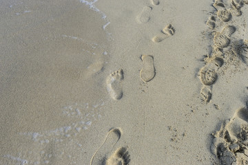 Fototapeta na wymiar Relax, Footprints in the sand of a beach by the Mediterranean se