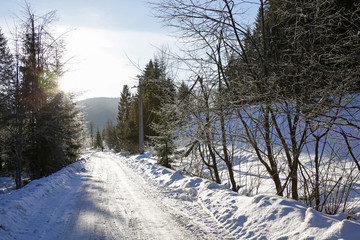 winter mountain landscape with road with colorful lens flares