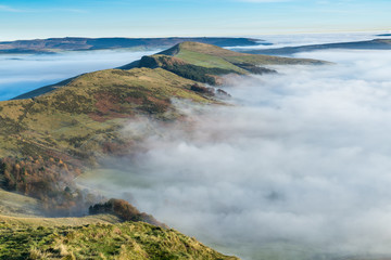 The view across the valley shrouded in mist at the peak of Mam Tor in the Peak District, Hope Valley on a cold winter morning