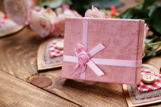 Gift box, heart shapes and roses