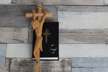 Christian prayer book, crucifix and marriage rings. Christian marriage.