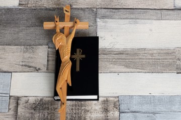 Catholic prayer book and crucifix. Religious background.