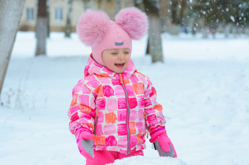 Little girl playing in the snow