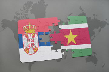 puzzle with the national flag of serbia and suriname on a world map