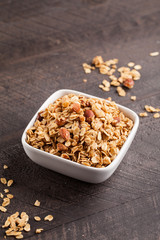 Homemade Nutty Cinnamon Granola with Honey on a dark wooden background