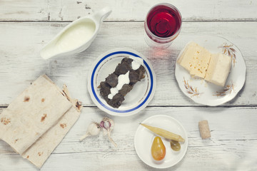 Dolma, cheese, wine and bread on the table