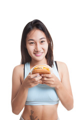 Beautiful Asian healthy girl enjoy eating  hamburger.