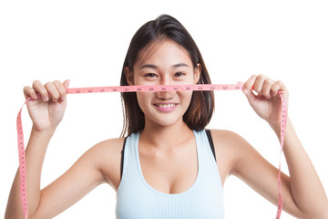 Beautiful Asian healthy girl with measuring tape.