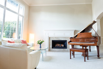 Living room decorated with leather sofa and piano with fireplace © tab62